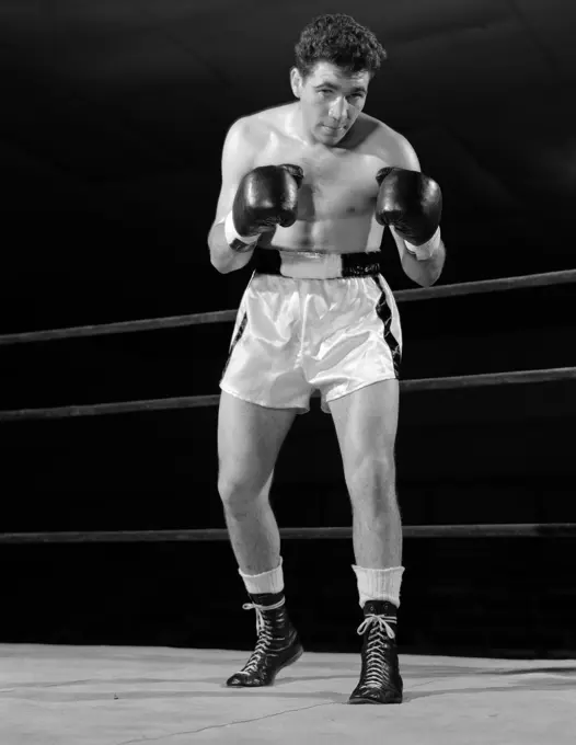 1950S Full Figure Boxer In Ring Facing Camera With Fists In Boxing Gloves