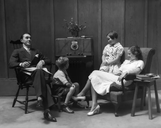 1930S 1940S Family Sitting In Living Room Listening To Radio