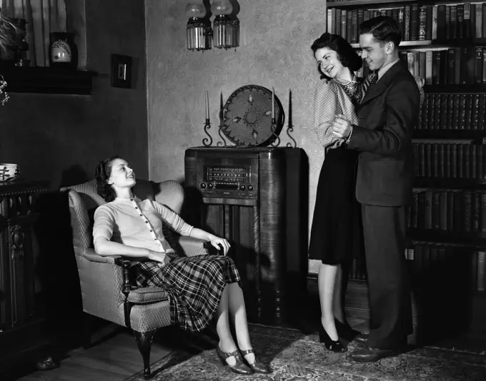 1940S Young Teenage Couple Dancing To Radio Woman Sitting In Chair