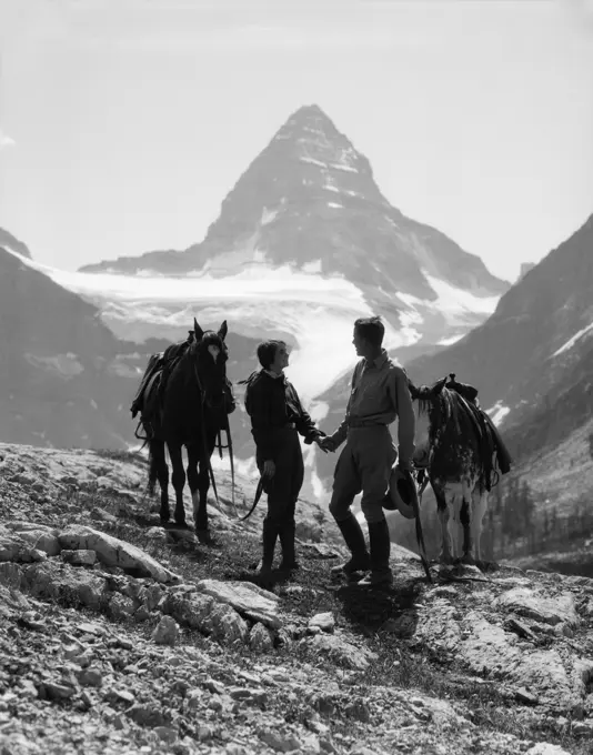 1930S Couple Man Woman Holding Hands Standing With Horses In Mountains Western Mt. Assiniboine Canada