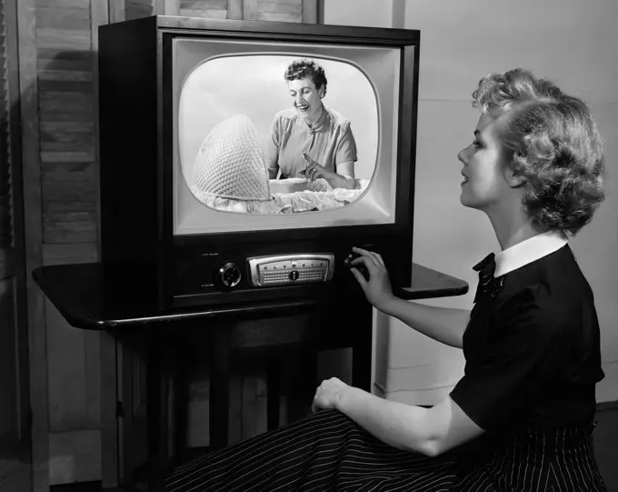 1950S Blonde Woman Turning Dial On Tv Set Studio Indoor