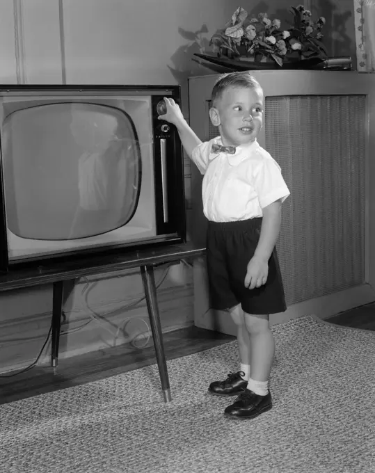 1950S Little Boy Playing With Television Dial