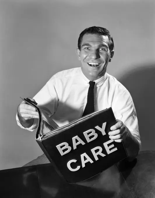 1960S Smiling Man Father Holding Baby Care Book