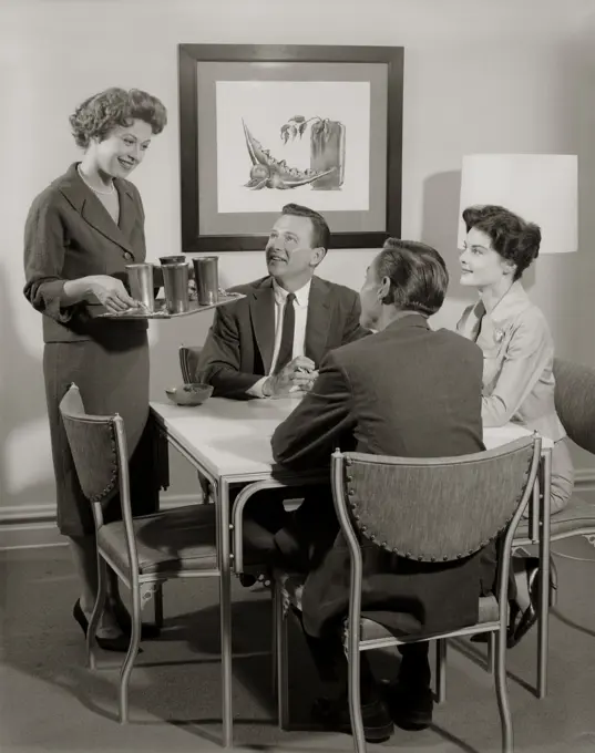 1950S Card Party Of 2 Couples With Woman Serving Drinks