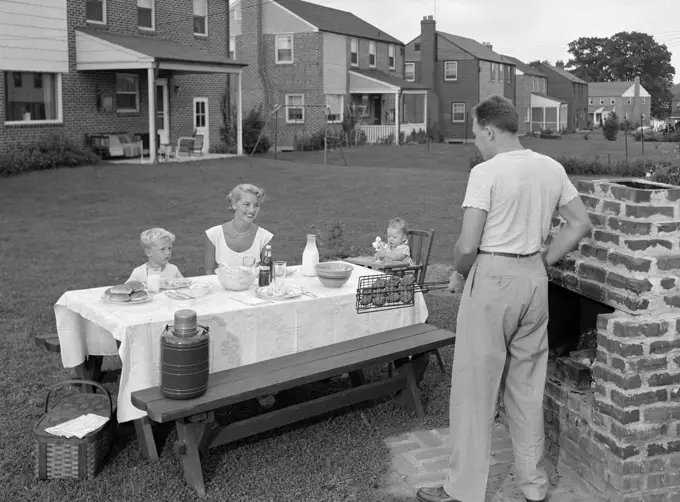 1950S Family In Backyard Cooking Hamburgers