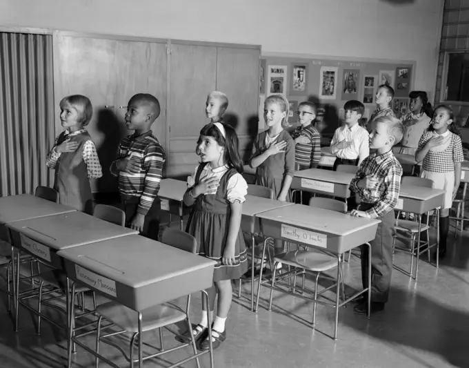 1960S Kids Saying Pledge Of Allegiance In Classroom