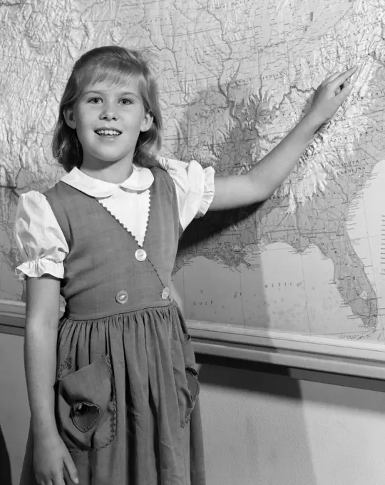 1960S Grade School Girl At Front Of Class Pointing To Map Of United States