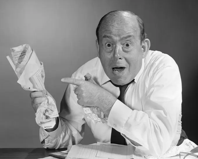 1960S Man Holding Crushed Papers In Hand