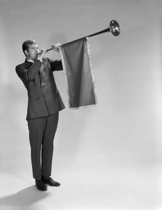 1960S Young Man Standing Blowing Herald'S Horn