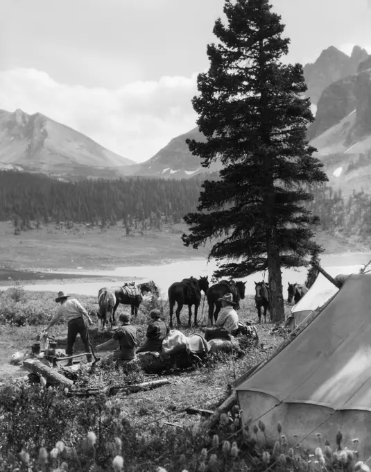 1920S 1930S Group Men Women Camping In Tents Horses With Riding Gear In Background Mountains Assiniboine Canada