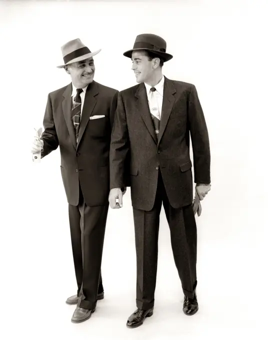 1950S Two Men Salesman Businessman Business Suit Tie Hat Smiling Walking Talking Side By Side