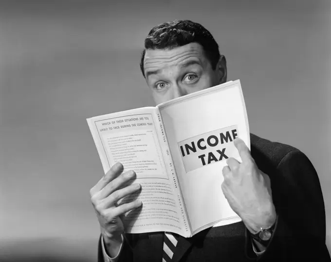 1950S Man In Suit Nose In Income Tax Book