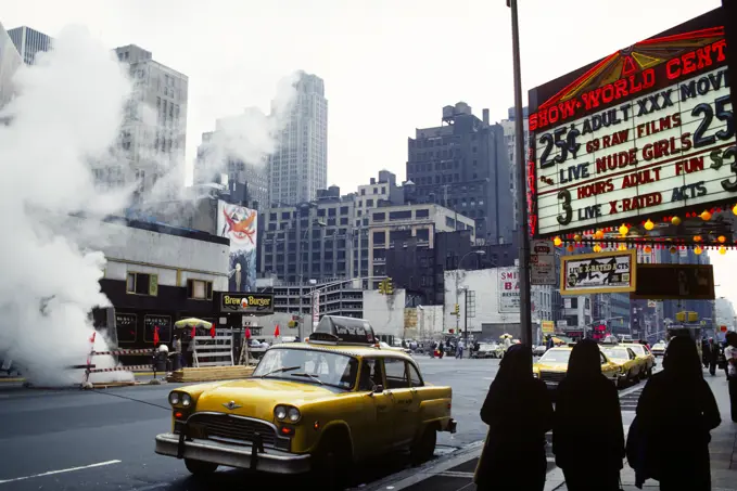 1970s VIEW OF BACKS OF THREE NUNS WALKING PAST MARQUEE FOR A PORN PALACE ON 8TH AVENUE AND 42ND STREET NEW YORK CITY NY USA