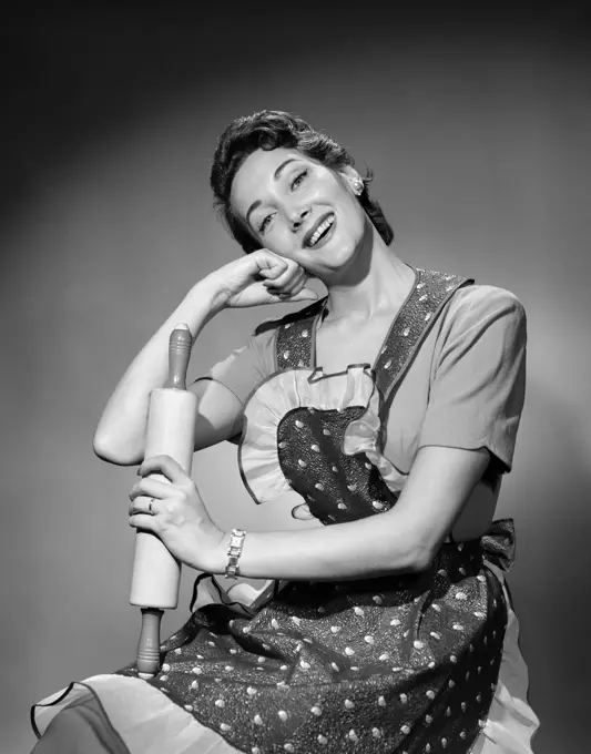 1950S Woman As Housewife Wearing Apron Holding Rolling Pin