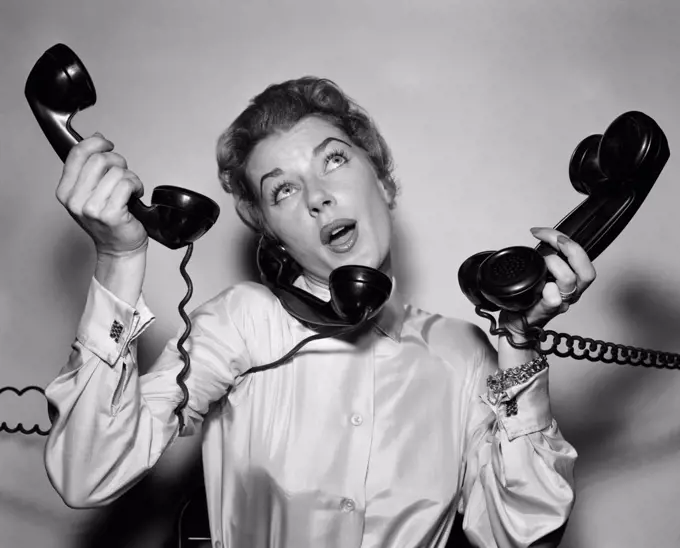1950S Harried Woman Holding Four Black Telephones Talking On One