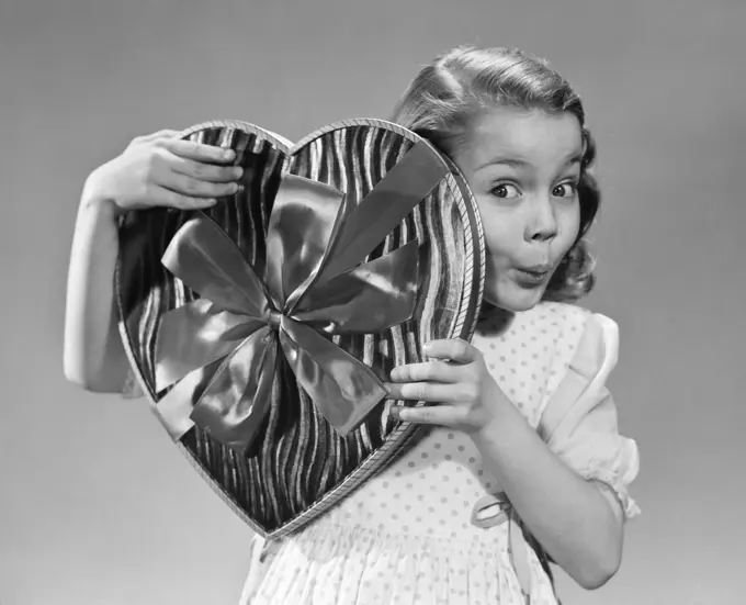 1950S Surprised Little Girl Peeking From Behind Big Heart Shaped Box Of Valentine Candy