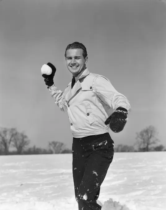 1930S Smiling Man Playing Outside About To Throw Snowball