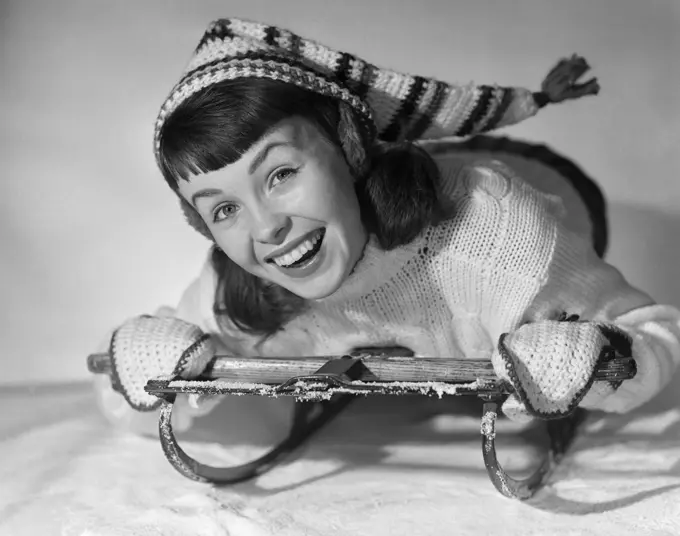 1950S Smiling Young Teenage Woman Posing On Sled In Winter Wool Knit Clothes