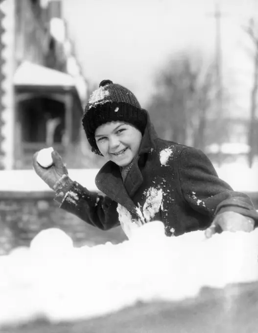 1920S 1930S Smiling Boy About To Throw Toss Snowball Playing Snow Fun Winter Cold Mischief