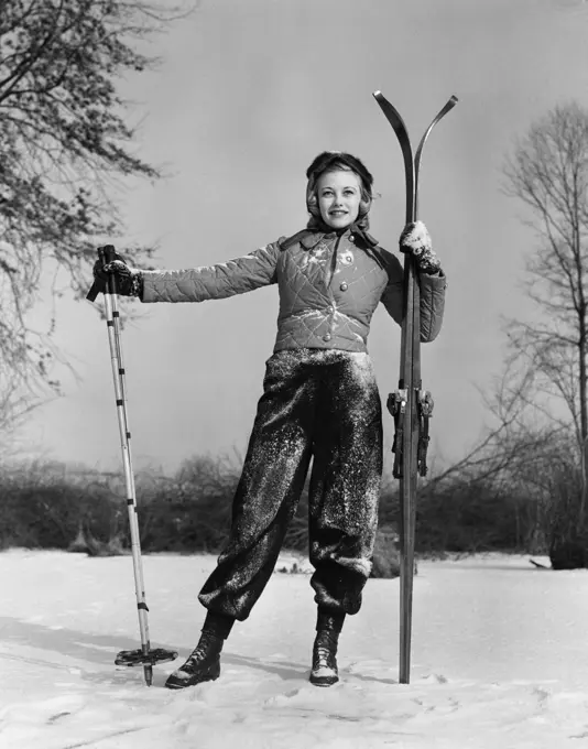 1930S Girl Standing Holding Skis And Poles Smiling