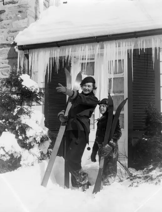 1930S Mother Son Standing Holding Skis In Front Of Winter House With Icicles