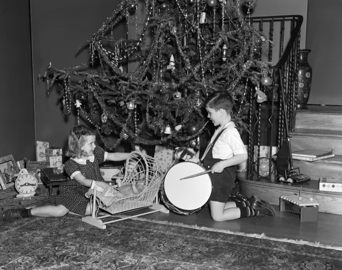 1930S Boy And Girl Playing With Presents By Christmas Tree