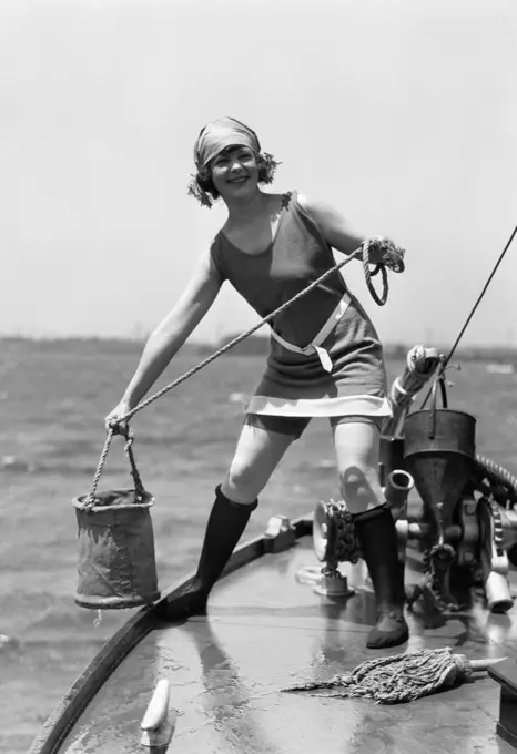 1920S Woman In Bathing Suit Pulling Bucket Of Water Aboard A Boat Outdoor