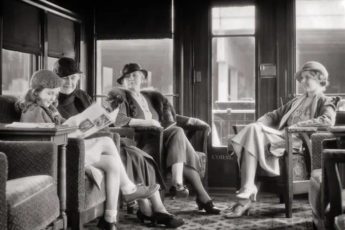 1930s THREE GENERATIONS TWO GRANDMOTHERS MOTHER PRETEEN DAUGHTER TRAVEL TOGETHER SITTING IN RAILROAD PASSENGER TRAIN PARLOR CAR