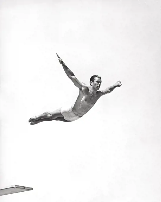 1930s 1940s MAN DIVER JUMPING OFF DIVING BOARD perfect form caught in mIdair