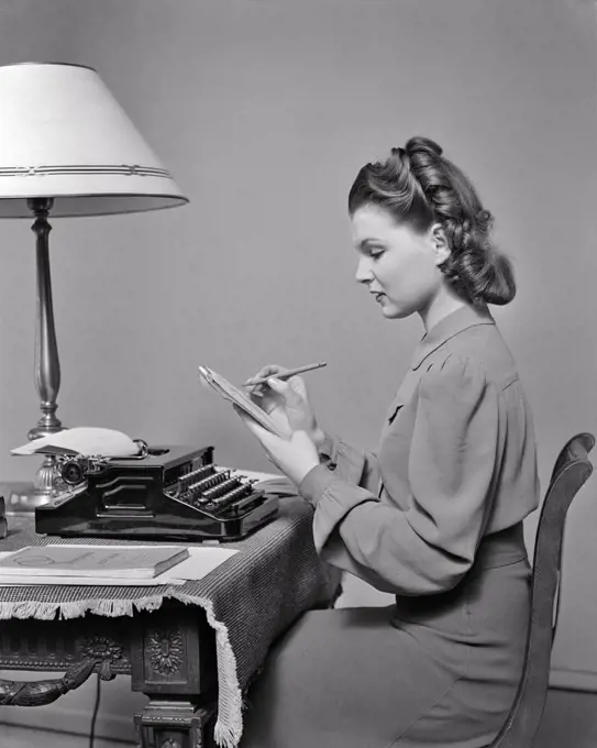 1940s PRIM AND PROPER YOUNG WOMAN AT HOME STUDYING PRACTICING WRITING EDITING TYPING AND STENOGRAPHY SELF MOTIVATED