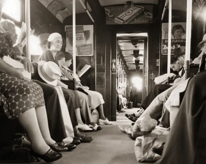 1930s INTERIOR OF HUDSON AND MANHATTAN SUBWAY TRAIN CAR WITH ANONYMOUS COMMUTERS GOING FROM JERSEY CITY NJ TO MANHATTAN NYC USA