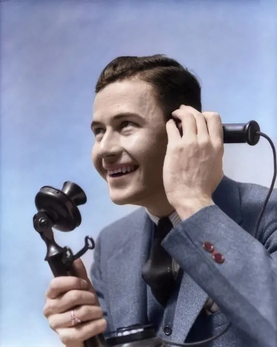 1920s 1930s MAN TALKING ON CANDLESTICK PHONE