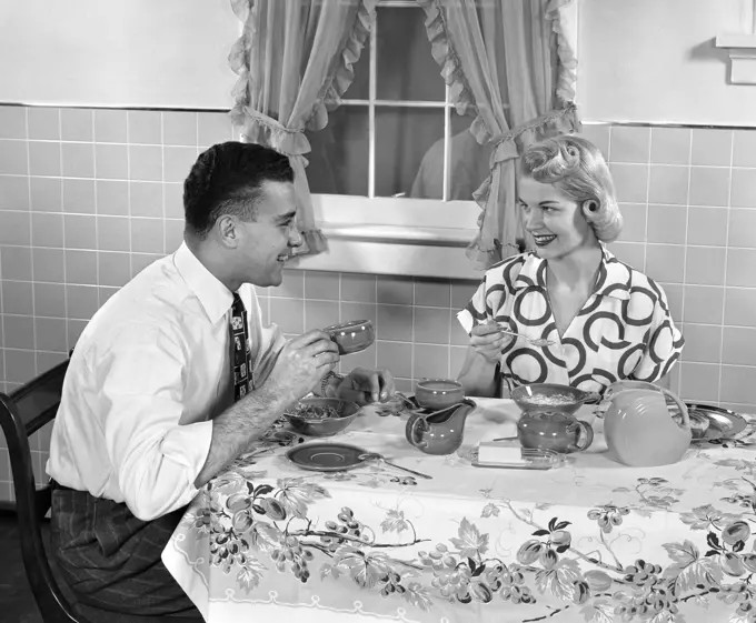 1950S Husband And Wife At Breakfast Eating Cereal & Drinking Coffee