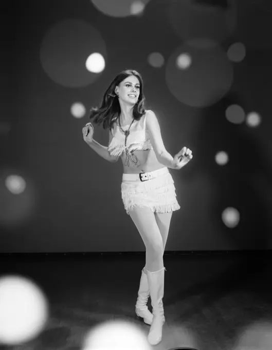 1960S Woman Dancing In White Fringed Halter Top Mini-Dress Skirt And Go-Go Boots