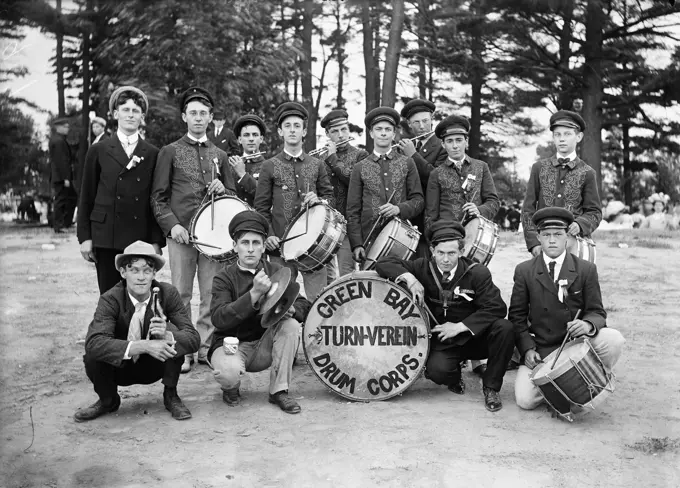 OUTDOOR GROUP PORTRAIT OF TURN OF THE CENTURY DRUM CORPS FLUTISTS IN BACK ROW