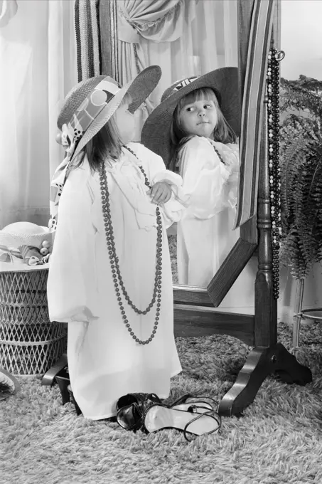 1980s LITTLE GIRL DRESSED UP IN ADULT CLOTHES POSING BEFORE MIRROR FUN PLAY ROLE PLAYING HAT BEAD NECKLACE 