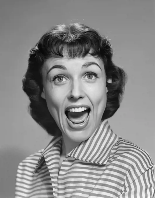 1950s 1960s WOMAN BRUNETTE SMILING LAUGHING MOUTH OPEN WIDE HAPPY FUNNY FACE LOOKING AT CAMERA WEARING STRIPED BLOUSE  