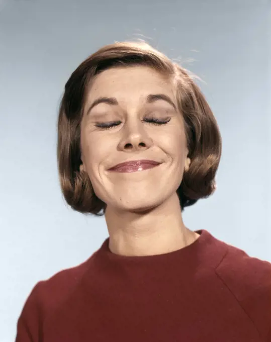 1960s PORTRAIT OF YOUNG WOMAN IN SWEATER WITH SMUG SMILE PLEASED AND HAPPY EXPRESSION