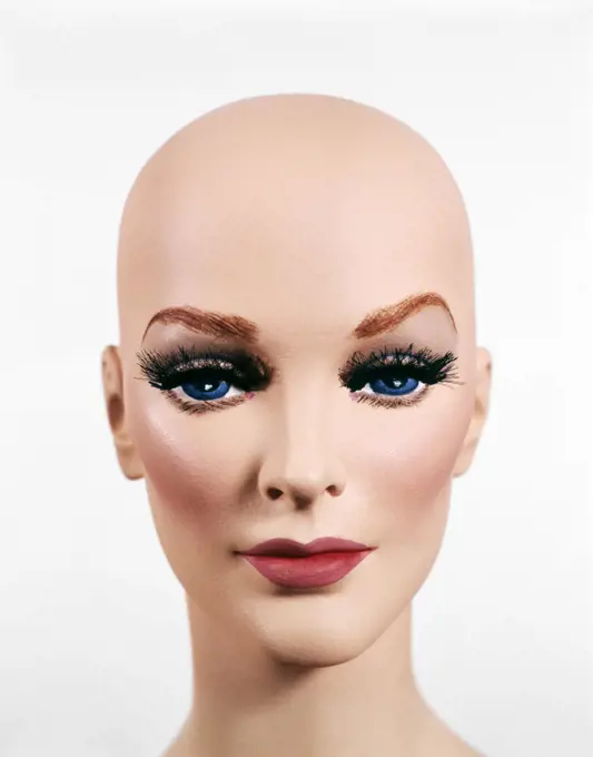 BALD HEAD OF FEMALE MANNEQUIN DUMMY LOOKING AT CAMERA 