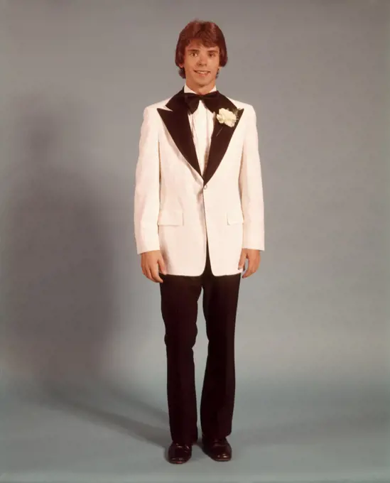 1970s TEEN BOY FULL FIGURE PORTRAIT WEARING FORMAL TUXEDO WHITE JACKET FOR PROM DATE STANDING LOOKING AT CAMERA
