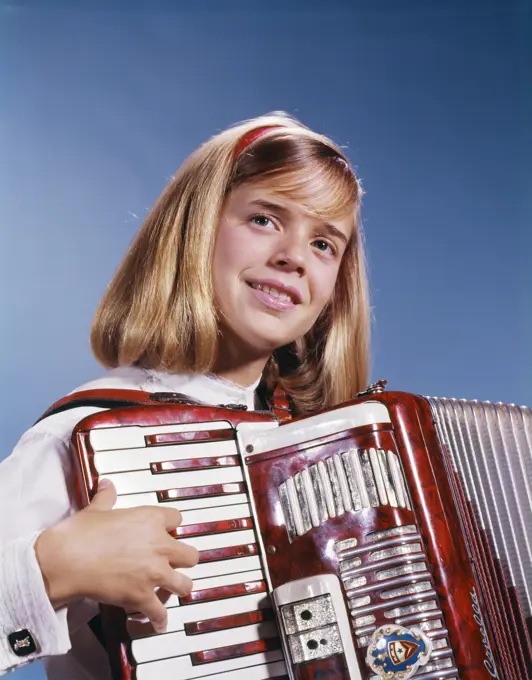 1960s 1970s TEENAGE GIRL SMILING PLAYING ACCORDION 