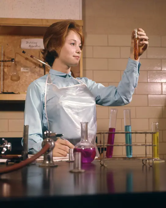 1960s COED FEMALE STUDENT CHEMISTRY LAB LABORATORY LOOKING AT TEST TUBE SCIENCE EDUCATION