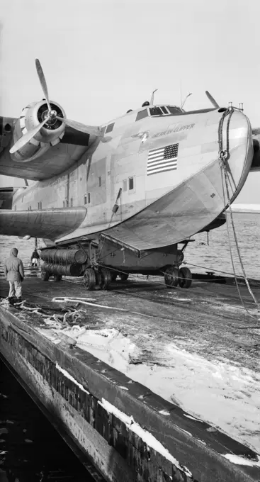 1930s 1940s PAN AMERICAN AIRWAYS FLYING BOAT CLIPPER BOEING 314 HELD BY MOORING LINE BEING LAUNCHED INTO WATER