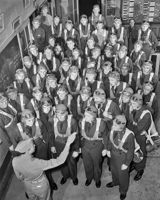 1940s NEW AVIATION OFFICERS GET LAST MINUTE PARACHUTE INSTRUCTION BEFORE TRAINING FLIGHT