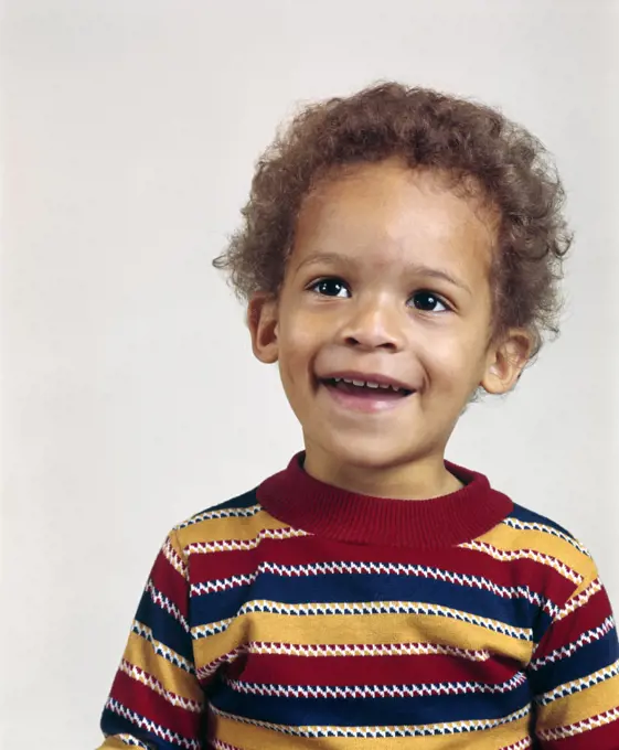 1970s PORTRAIT SMILING AFRICAN AMERICAN TODDLER BOY WEARING STRIPED T-SHIRT