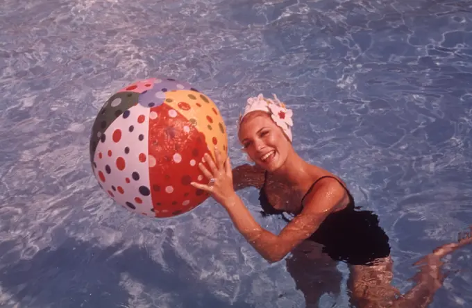 1960S Woman In Swimming Pool Holding Beach Ball