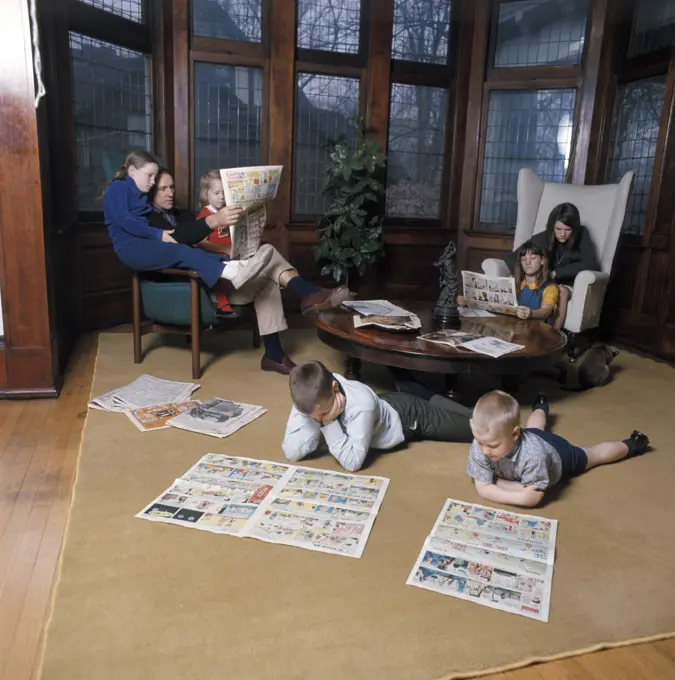 1970S Family Of 7 Reading Sunday Newspapers And Comics In Living Room