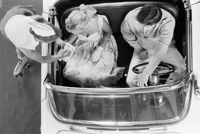 1950S Set-Up Of Carhop On Roller Skates Taking Order From Couple In 1955 T-Bird Convertible