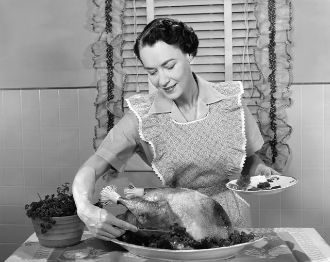 1960S Woman In Apron Dishing Cranberry Sauce Out Around Turkey