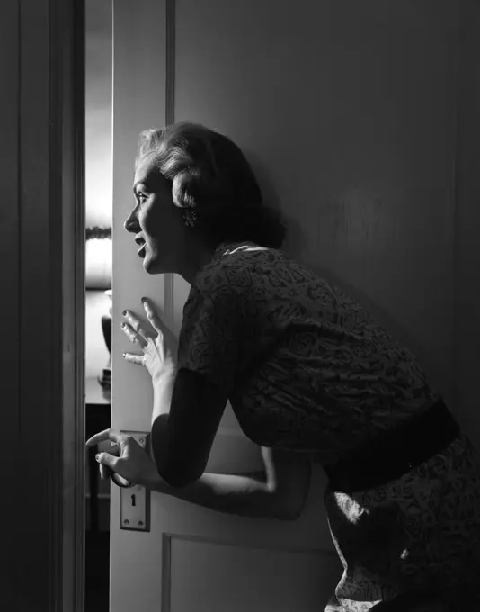 1950S Woman Peeking Through Open Door